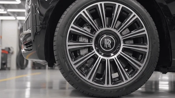 Luxury vehicle wheel and tyre in a workshop, showcasing professional mobile tyre fitting and replacement services
